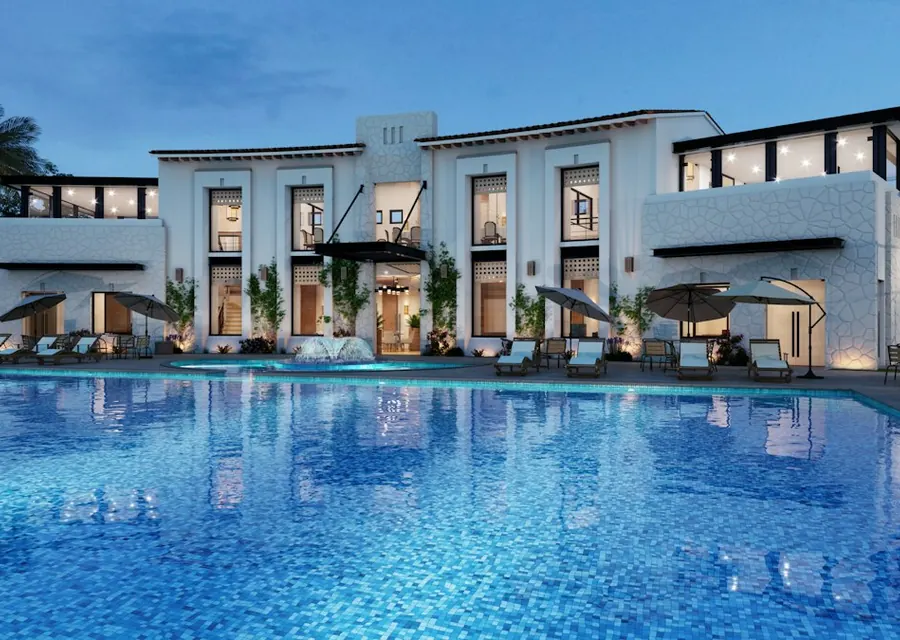 Hotel building with an outdoor pool at dusk